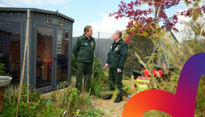 EEAST staff standing and talking inside a wellbeing garden